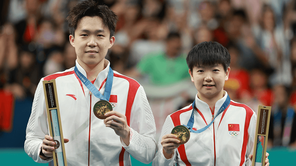 Wang Chuqin and Sun Yingsha winning Olympic Mixed Gold.png